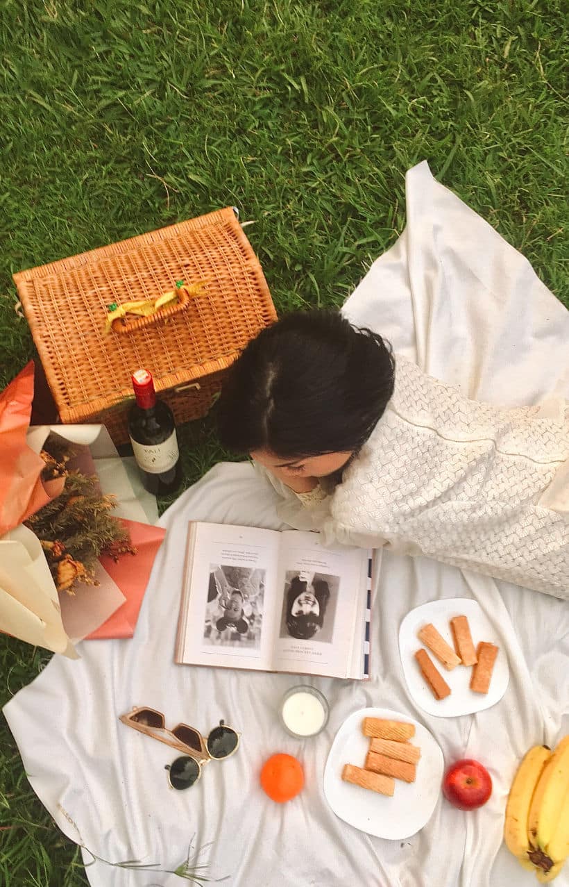 girl-having-a-picnic representation of the green spaces at The Groves Lithonia apartments